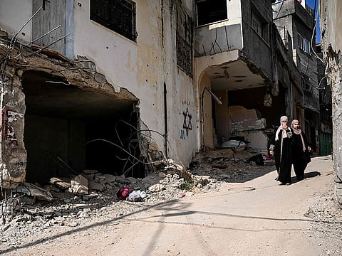 Residents walk amid the destruction following an Israeli military raid in the Jenin refugee camp, in West Bank on September 6, 2024. Israeli forces withdrew from on September 6 after a deadly 10-day operation.