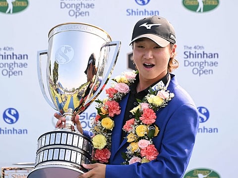 Kensei Hirata of Japan poses with the trophy after his victory in the 40th Shinhan Donghae Open golf tournament at Club72 Country Club in Incheon on Sunday.