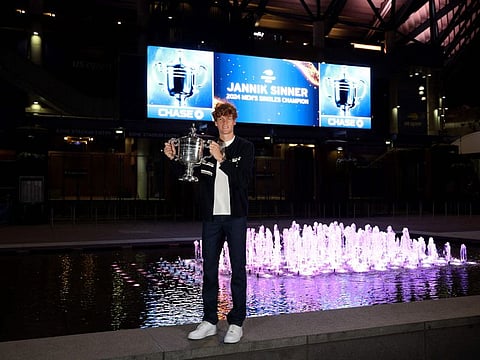 Jannik Sinner of Italy poses for a photo with the winners trophy outside of Arthur Ashe Stadium after defeating Taylor Fritz of the United States to win the men's singles final of the 2024 US Open at USTA Billie Jean King National Tennis Centre on Sunday.