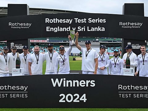 England's Ollie Pope holds aloft the trophy with Josh Hull during the winners' presentation at The Oval cricket ground in London on Monday.