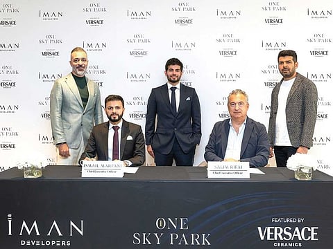 Ismail Marfani, Chief Executive Officer of IMAN Developers, signed an agreement with Salim Rifai, Versace Ceramics spokesperson.