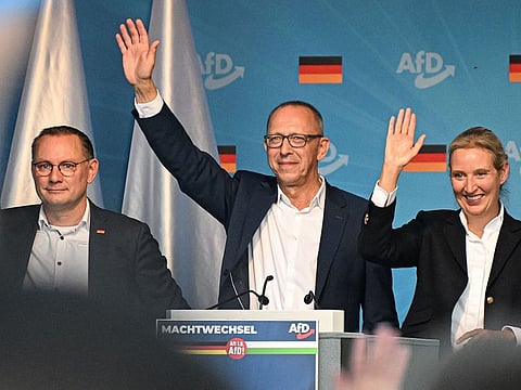 (L-R) Co-leader of the far-right Alternative for Germany (AfD) party Tino Chrupalla, top candidate of the far-right Alternative for Germany party (AfD) for the upcoming Saxony state elections Joerg Urban and co-leader of the far-right Alternative for Germany (AfD) party Alice Weidel wave on stage during a campaign event in the historic center of Dresden, eastern Germany on August 29, 2024.