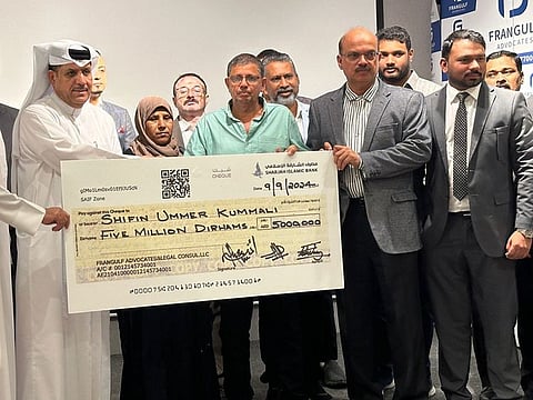 Parents of Shifin Ummer Kummali receive a ceremonial cheque for Dh5 million from the legal team at FranGulf Advocates and Legal Consultants in Dubai