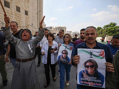 Palestinians and international activists lift portraits of slain Turkish-American activist Aysenur Ezgi Eygi as they arrive for her final farewell at the Rafidia hospital morgue in Nablus in the occupied West Bank on September 8, 2024.