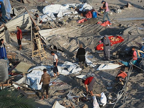 Palestinians inspect the damage at the site of Israeli strikes on a makeshift displacement camp in Mawasi Khan Yunis in the Gaza Strip on September 10, 2024, amid the ongoing war between Israel and Palestinian militant group Hamas.