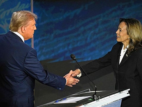 US Vice President and Democratic presidential candidate Kamala Harris (R) shakes hands with former US President and Republican presidential candidate Donald Trump during a presidential debate at the National Constitution Center in Philadelphia, Pennsylvania, on September 10, 2024.