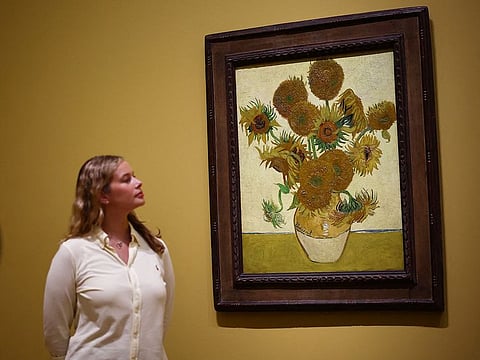 Visitors look at a painting made by late Dutch artist Vincent Van Gogh "Sunflowers" 1888, during a press preview for "Van Gogh: Poets and Lovers" exhibition at the National Gallery, in London, on September 9, 2024.