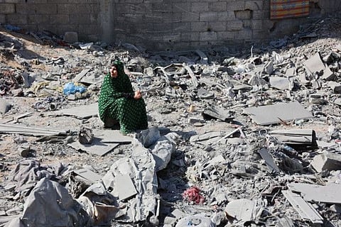 A Palestinian woman sits next to debris at the site of an Israeli strike in the Shejaiya suburb east of Gaza City on September 12, 2024, amid the ongoing war between Israel and Palestinian militants.