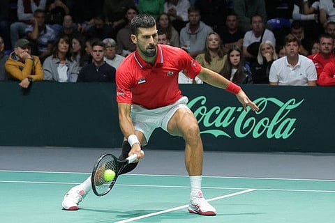 Serbia's Novak Djokovic returns the ball to Greece's Petros Tsitsipas and Aristotelis Thanos during the group stage men's doubles match of the Davis Cup tennis tournament at the Aleksandar Nikolic Hall in Belgrade on Sunday.