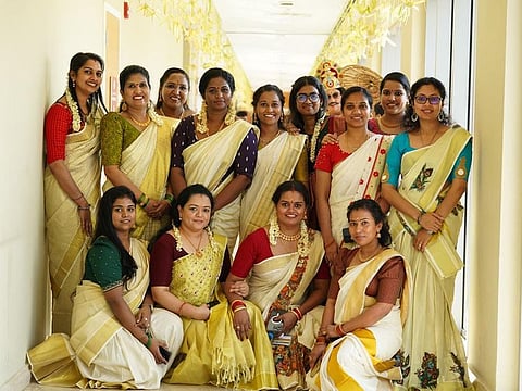 Malayali nurse Jinsu Ann Sabu (standing far right) and colleagues celebrate Onam at a hospital in Dubai