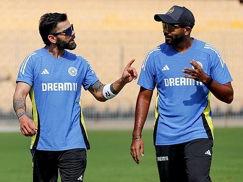 India's Virat Kohli and Jasprit Bumrah in conversation during a practice session ahead of the Test series against Bangladesh, at M. A. Chidambaram Stadium, in Chennai.