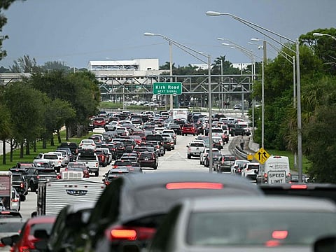 Cars are stuck in traffic after police blocked the road in West Palm Beach, Florida, on September 15, 2024 following a shooting incident at former US president Donald Trump's golf course.