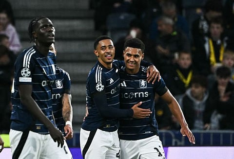 Aston Villa's English midfielder Jacob Ramsey (centre) is congratulated by forward Ollie Watkins (right) after scoring his team's second goal during the Uefa Champions League 1st round day against Young Boys at the Wankdorf Stadium in Bern, on Tuesday.