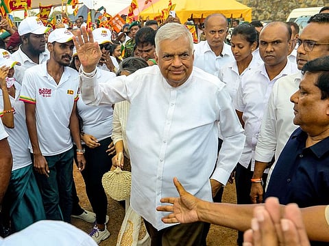 Sri Lanka's president and independent presidential candidate Ranil Wickremesinghe (C) greets his supporters during an election rally ahead of the upcoming presidential elections in Galle on September 18, 2024.