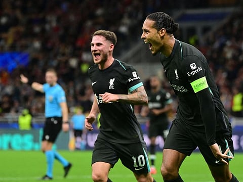 Liverpool's Dutch defender Virgil van Dijk (right) celebrates scoring his team's second goal during the Uefa Champions League 1st round day 1 football match against AC Milan at the San Siro stadium in Milan on Tuesday.