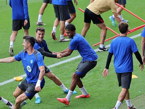 Barcelona's Spanish forward #19 Lamine Yamal (centre) and Spanish midfielder Gavi take part in a training session on the eve of the Uefa Champions League football match at the Joan Gamper training ground in Sant Joan Despi, near Barcelona, on Wednesday.