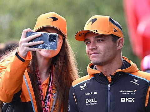 McLaren's British driver Lando Norris poses for a 'selfie' as he walks in the paddock ahead of the Formula One Belgian Grand Prix at the Spa-Francorchamps circuit in Spa on July 26.