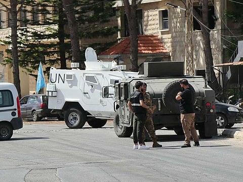 This picture shows a UN vehicle and Lebanese army forces standing guard near the site of a controlled explosion after a communication device found on the ground in southern Lebanon, between the villages of Burj al Muluk and Klayaa, on September 19, 2024.