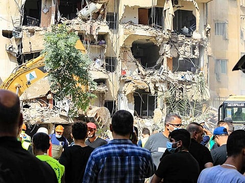 People gather at the scene of an Israeli strike that targeted Beirut's southern suburbs a day earlier, as search and rescue operations continue on September 21, 2024.