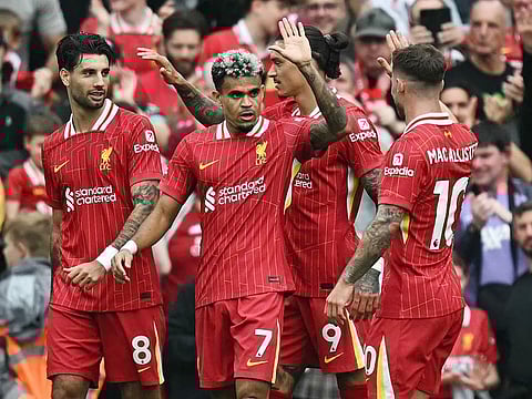Liverpool's Luis Diaz (centre) celebrates with teammates during their winning campaign in the English Premier League.