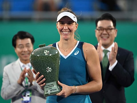 Brazil's Beatriz Haddad Maia celebrates with the trophy after defeating Russia's Daria Kasatkina in their women's singles final match at the Korea Open tennis championships in Seoul on Sunday.