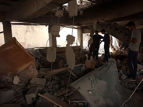 Palestinians inspect the damage at the site of an Israeli strike on a school housing displaced Palestinians in Gaza City's Zaytoun neighbourhood on September 21, 2024.