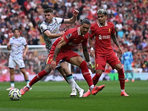 Liverpool's Uruguayan striker Darwin Nunez and Colombian midfielder Luis Diaz challenge Bournemouth's Scottish midfielder Ryan Christie during the English Premier League football match at Anfield in Liverpool, northwest England, on Saturday.