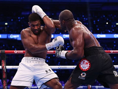 Britain's Anthony Joshua (left) defends against Britain's Daniel Dubois during their heavyweight boxing match for the IBF world title at Wembley Stadium in London on September 21.