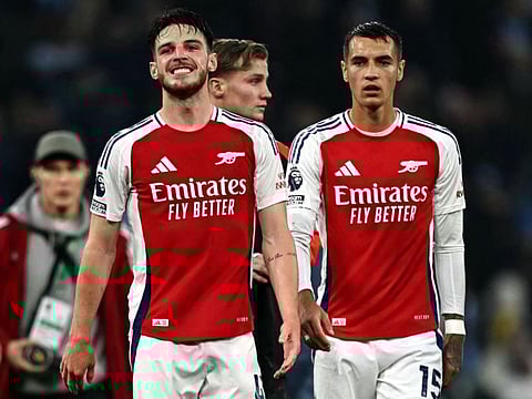 Arsenal's English midfielder Declan Rice (left) reacts following the English Premier League football match against Manchester City at the Etihad Stadium in Manchester, north west England, on Sunday.