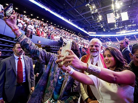 Prime Minister Narendra Modi greets members of the Indian diaspora after addressing the gathering, at Nassau Coliseum in New York.
