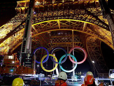 Cranes remove the Olympic rings from the Eiffel Tower in Paris, on September 27, 2024.