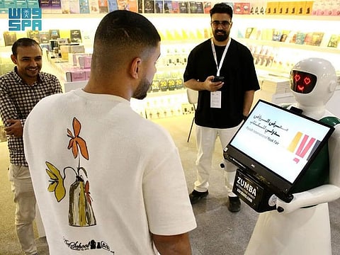 A robot welcomes visitors to the Riyadh book fair.