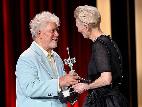 Spanish director Pedro Almodovar receives the Donostia Lifetime Achievement Award in recognition of his career from the British actress Tilda Swinton, during the 72nd San Sebastian International Film Festival in the northern Spanish Basque city of San Sebastian on September 26, 2024.