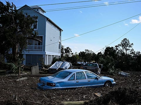 Debris surrounds a damaged car after Hurricane Helene made landfall in Steinhatchee, Florida.