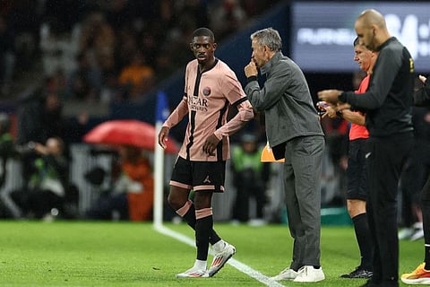 Paris Saint-Germain's Spanish head coach Luis Enrique gives instructions to French forward Ousmane Dembele during the French L1 football match against Stade Rennais FC at The Parc des Princes Stadium in Paris on September 27.