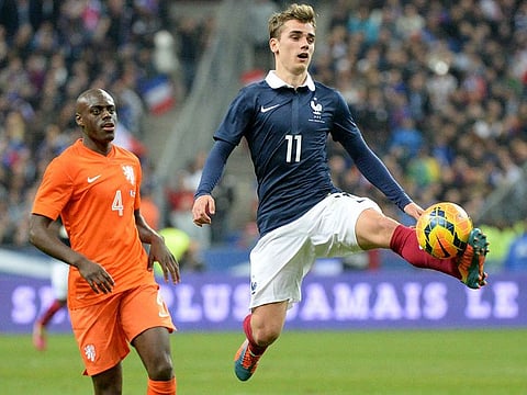 France's forward Antoine Griezmann (right) jumps for the ball next to Netherlands' defender Bruno Martins Indi during a friendly match at Stade de France in Saint-Denis.