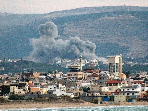 A cloud of smoke erupting after an Israeli air strike on the village of Qlayleh.