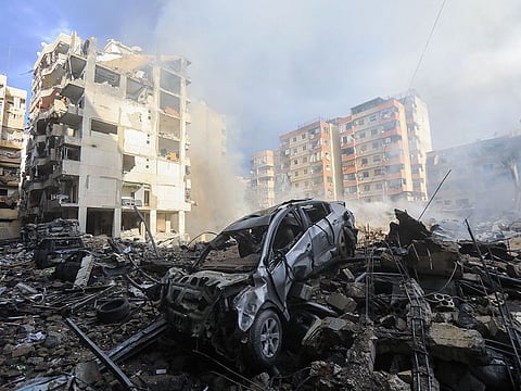 Smoke seeps out from building rubble at the site of an overnight Israeli airstrike on the Laylaki neighbourhood in Beirut's southern suburbs on October 1, 2024.