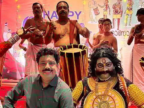 Malayali author and writer Anand Nilekantan with theatre actors as they stage a performance for Onam