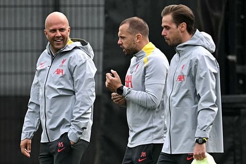 Liverpool's Dutch manager Arne Slot (left) and Dutch assistant manager Johnny Heitinga arrive before leading a training session on the eve of their Uefa Champions League 1st round day 2 football match against Bologna, at the AXA training centre in Liverpool, north west England, on Tuesday.