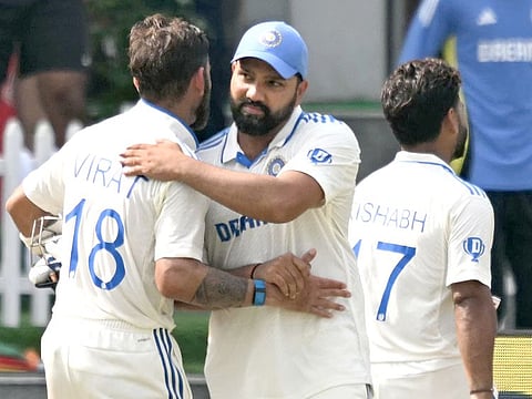 India's captain Rohit Sharma (C) embraces his teammate Virat Kohli (L) after winning the fifth and final day of the second Test against Bangladesh at the Green Park Cricket Stadium in Kanpur on October 1, 2024.