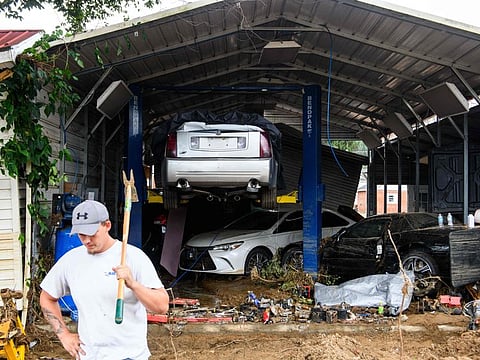 Vehicles damaged from flooding and debris are seen in the aftermath of Hurricane Helene in Old Fort, North Carolina.