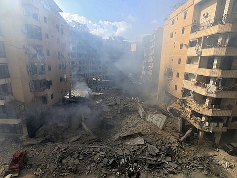 Rescuers check the destruction at the site of an overnight Israeli airstrike in Beirut's southern suburb of Shayyah.