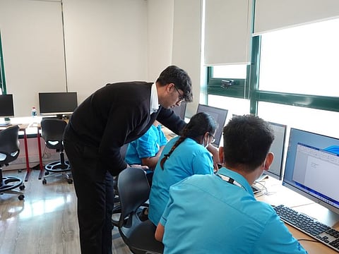 Support staff of Jumeriah College learning computer skills a free student initiative in Dubai