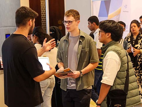 Students interacting with an admission officer at Edufair