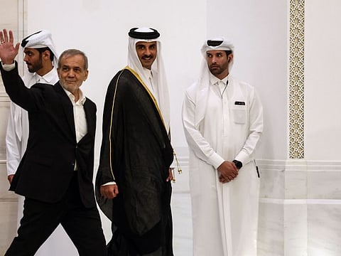 Iran's President Masoud Pezeshkian and Qatar's Emir Sheikh Tamim bin Hamad Al Thani arrive to give a joint press conference in Doha on October 2, 2024.