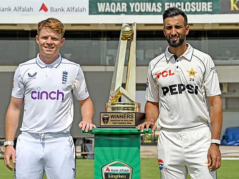 England's captain Ollie Pope (left) and his Pakistani counterpart Shan Masood pose with the Test series trophy on the eve of their first Test cricket match at the Multan Cricket Stadium in Multan on Sunday.