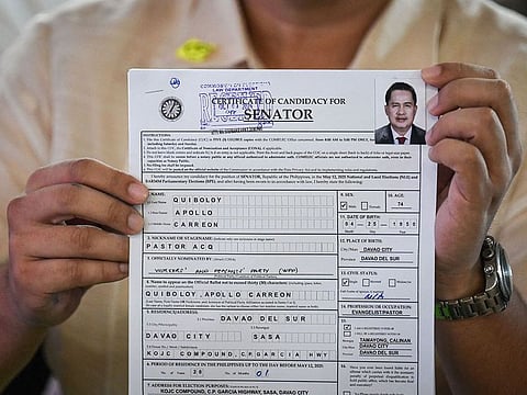 Lawyer Mark Christopher Tolentino holds the application of Apollo Quiboloy, pastor and founder of the Philippine-based Kingdom of Jesus Christ (KOJC) church, as he files his candidacy for senator in the May 2025 midterm elections, in Manila on October 8, 2024.