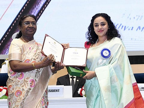 President Droupadi Murmu presents National Award to actor Nithya Menen for Best Actress award - Thiruchitrambalam, at the 70th National Film Awards, at Vigyan Bhavan in New Delhi