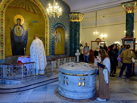 People pray and take a vow at the Our Lady of Vefa church in Istanbul, on October 1, 2024.